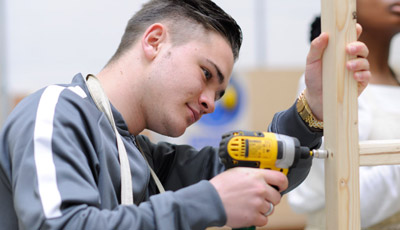 Student using a power drill